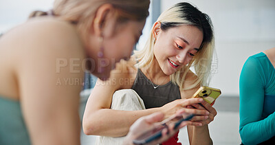 Buy stock photo Cellphone, friends and women in dance studio with networking, communication or browsing social media. Smile, phone and Japanese ballerinas watching online video for classic technique at rehearsal.