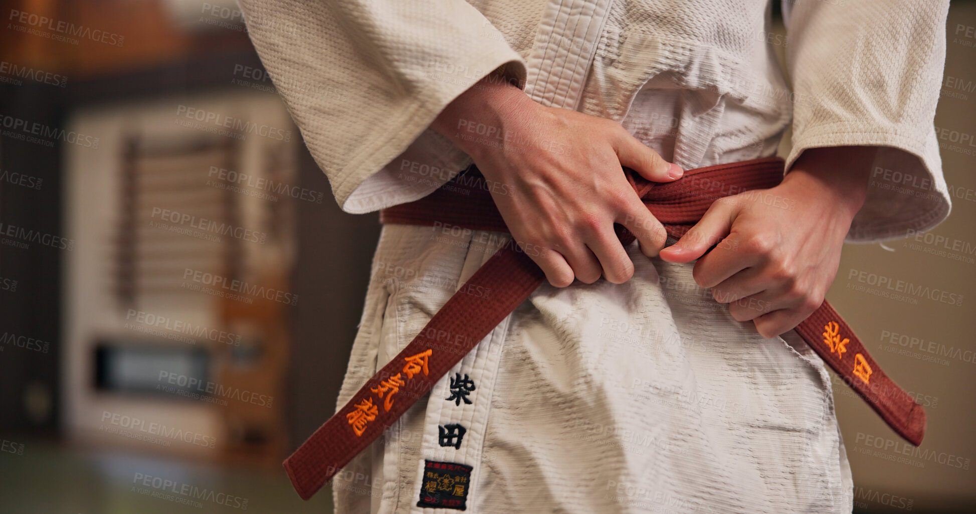 Buy stock photo Person, hands and red belt for karate with exercise, ready and prepare for training in Japan studio. Man, martial arts and professional fighter in dojo for sport, expertise and sensei in self defense