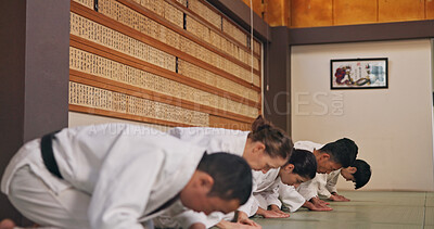 Buy stock photo Bow, respect and people in martial arts studio for practice, training or self defense class. Culture, karate and group of students with greeting or etiquette gesture to master in dojo for honor.