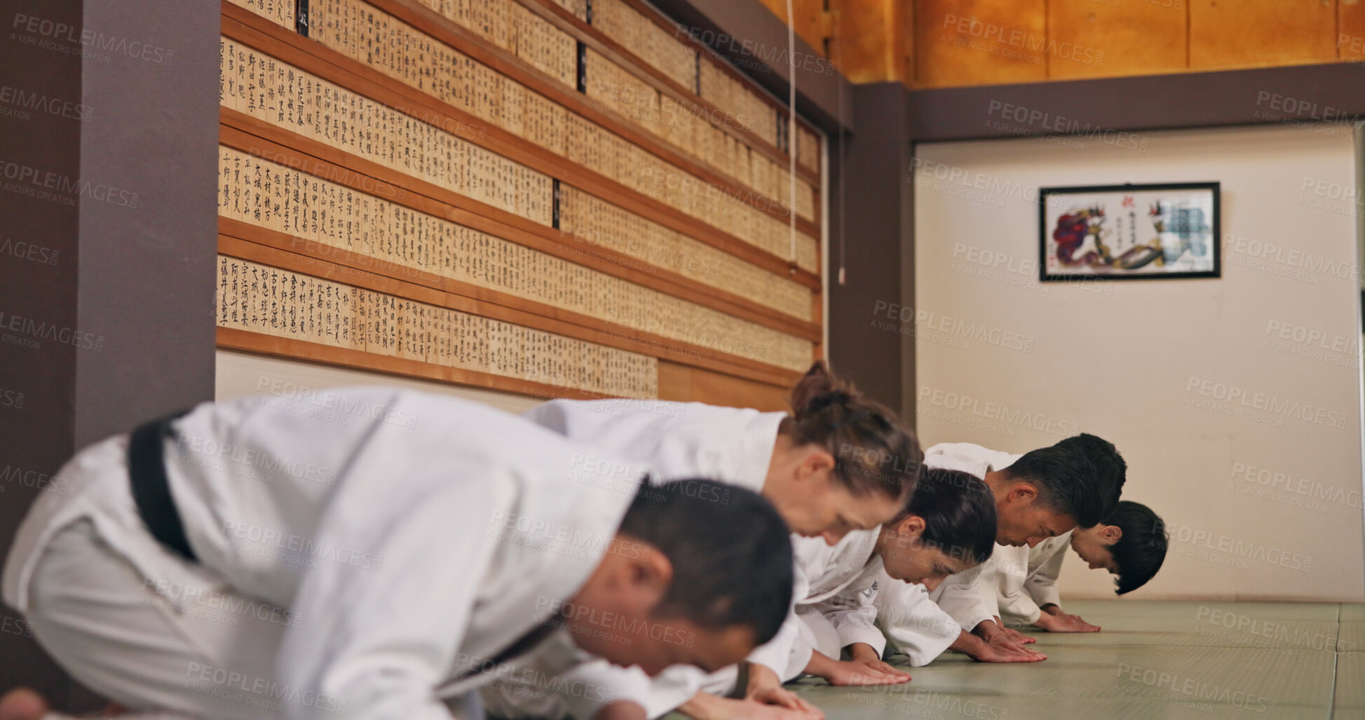 Buy stock photo Bow, respect and people in martial arts studio for practice, training or self defense class. Culture, karate and group of students with greeting or etiquette gesture to master in dojo for honor.