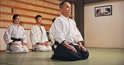 Buy stock photo Kneeling, greeting and people in martial arts studio for practice, training or self defense class. Culture, karate and group of students with respect or etiquette gesture to master in dojo for honor.