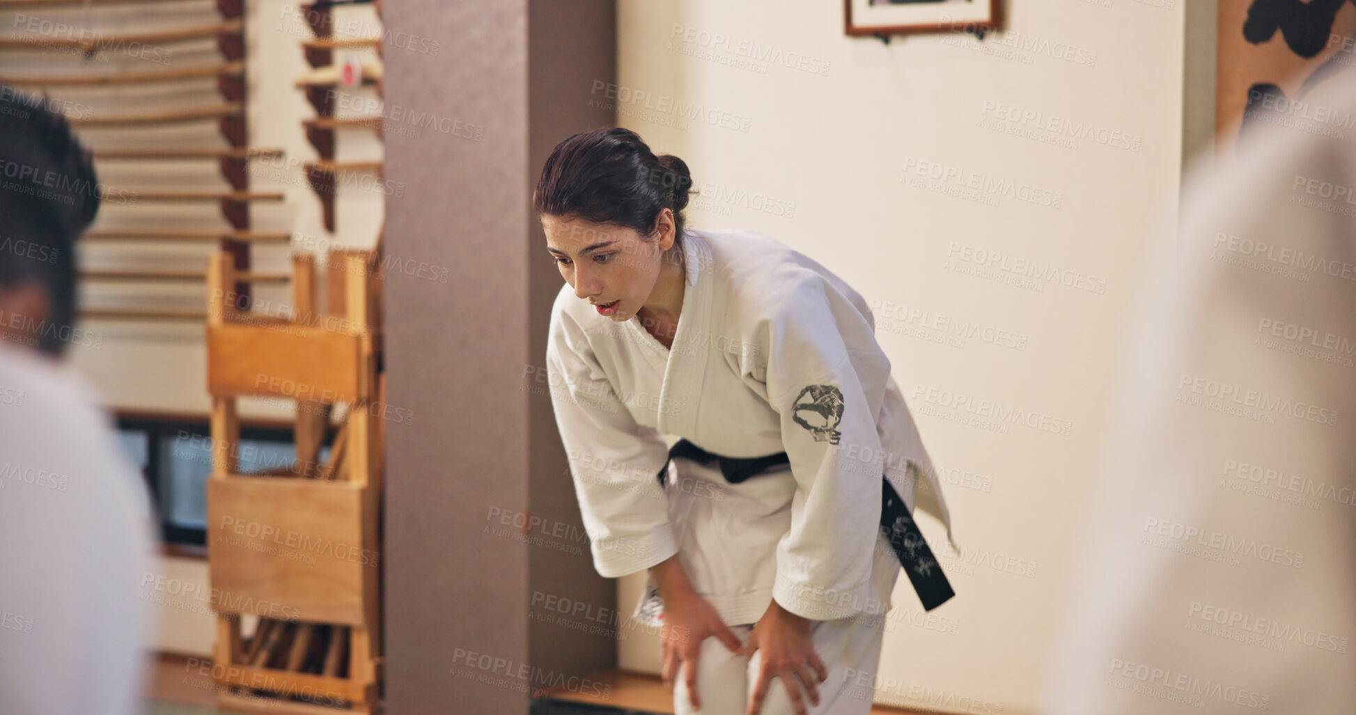 Buy stock photo Martial arts, woman and bow with respect in dojo for honor, self defense training and discipline in class. Japanese culture, aikido and person with traditional greeting for etiquette and gratitude