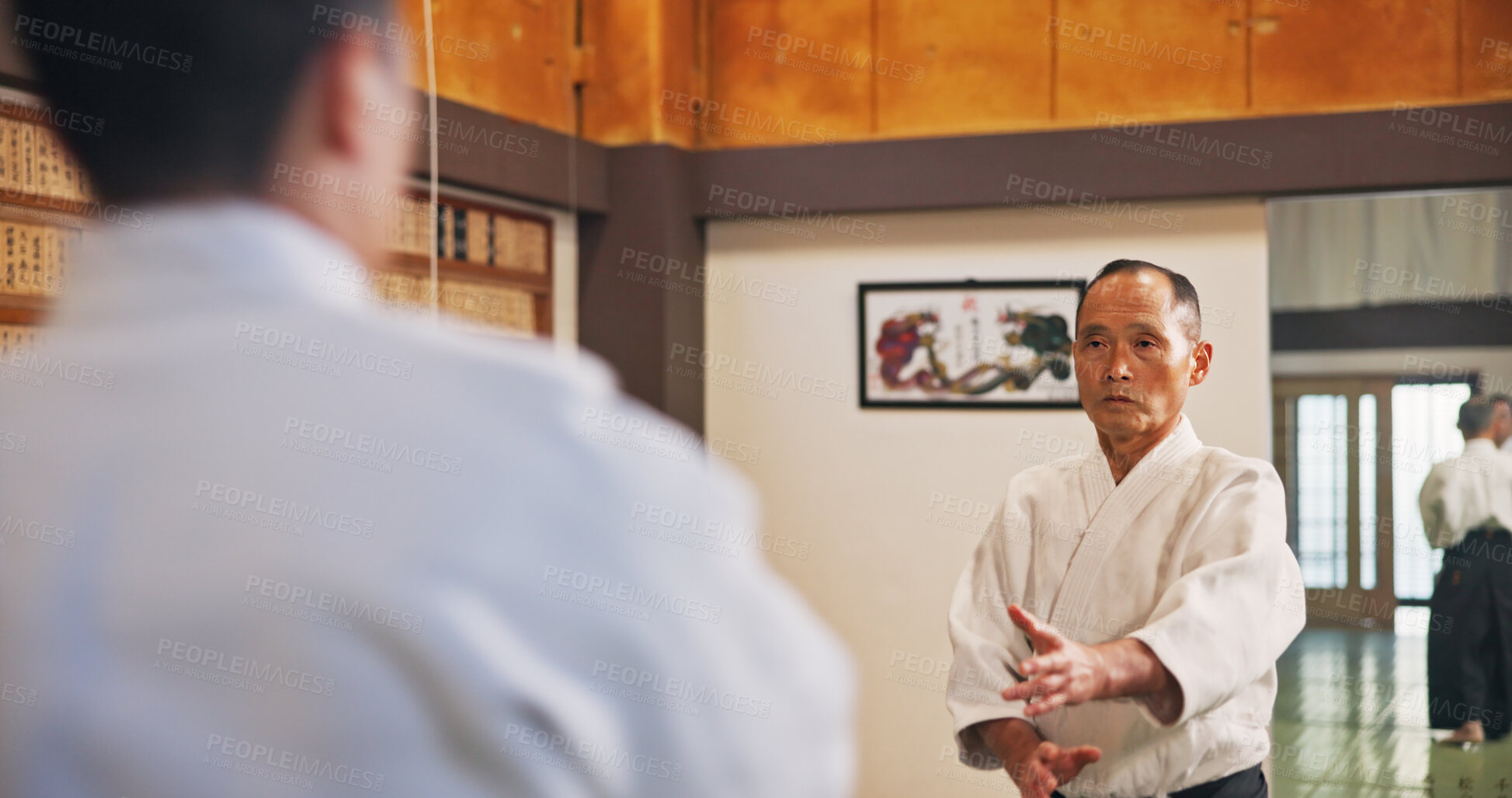 Buy stock photo Man, karate and student in class for learning, safety training and start fight for self defense. Mature sensei, Japanese people and martial arts in dojo for traditional sport, lesson and discipline