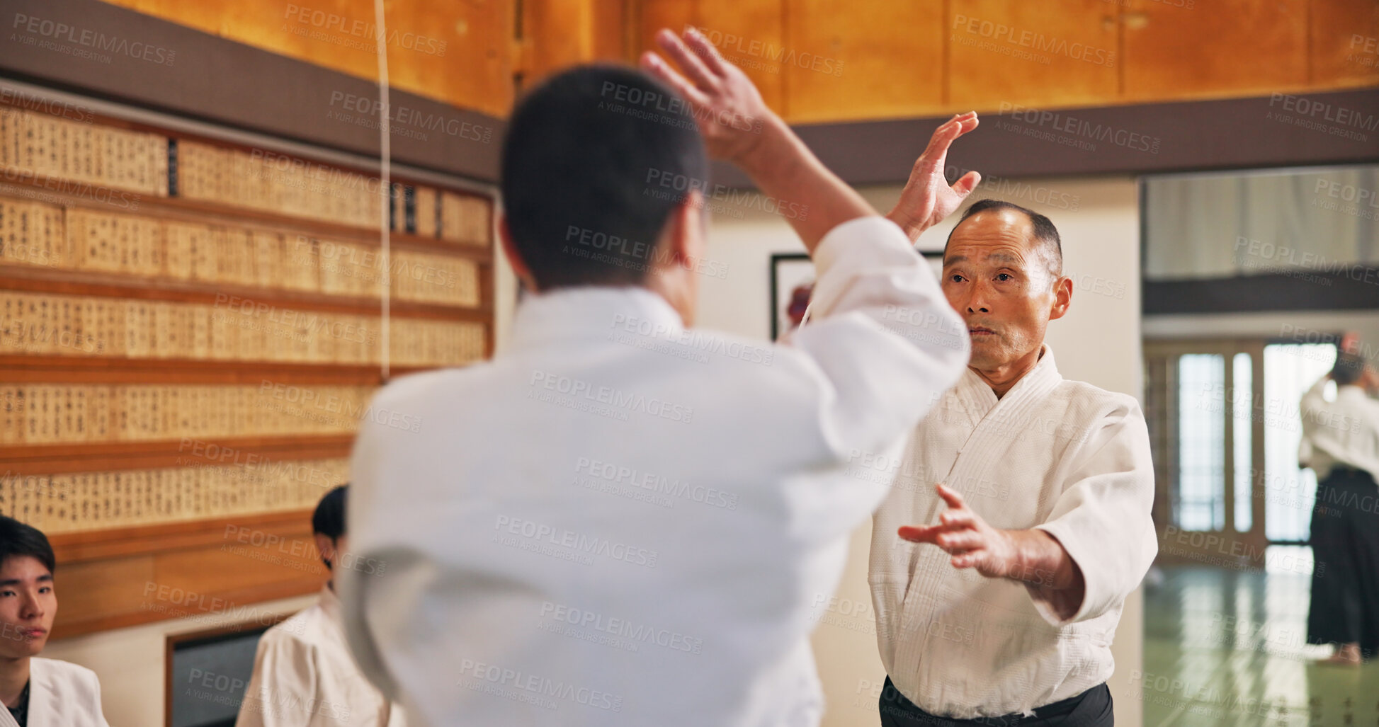 Buy stock photo Man, martial arts and student in class for learning, safety training and start fight for self defense. Mature sensei, Japanese people and karate in dojo for traditional sport, lesson and discipline