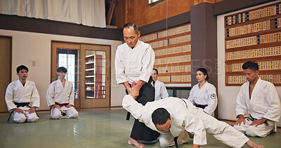 Buy stock photo Karate, martial arts and self defense with instructor in dojo for demonstration, fitness or training. Challenge, grappling or technique with Sensei and student people in Japan for combat or fighting