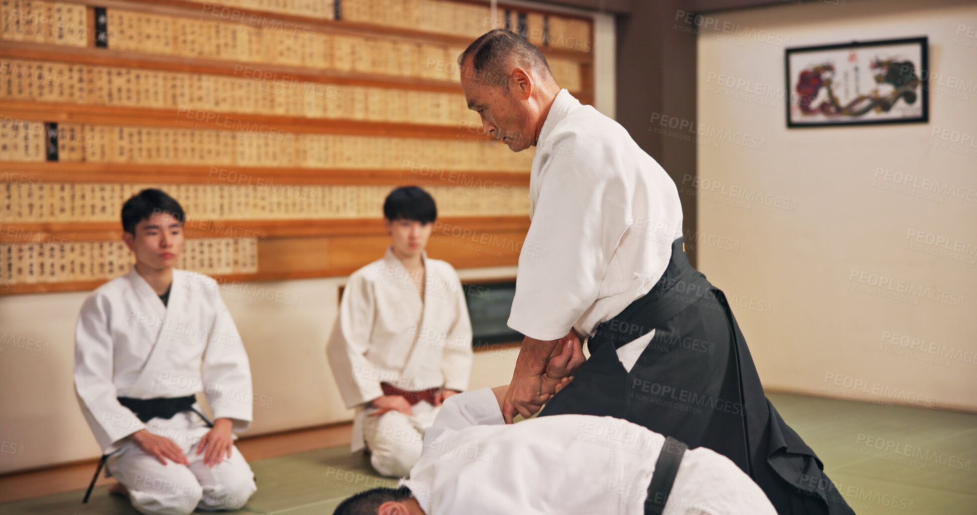 Buy stock photo Karate, martial arts and self defense with Sensei in dojo for challenge, fitness or training. Demonstration, grappling or technique with instructor and student people in Japan for combat, fighting