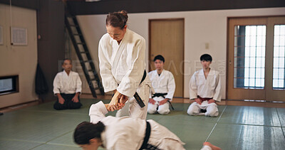 Buy stock photo Karate, martial arts and submission with people in dojo for demonstration, fitness or training. Challenge, self defense or technique with Sensei and student in Japan for combat, fighting or sports