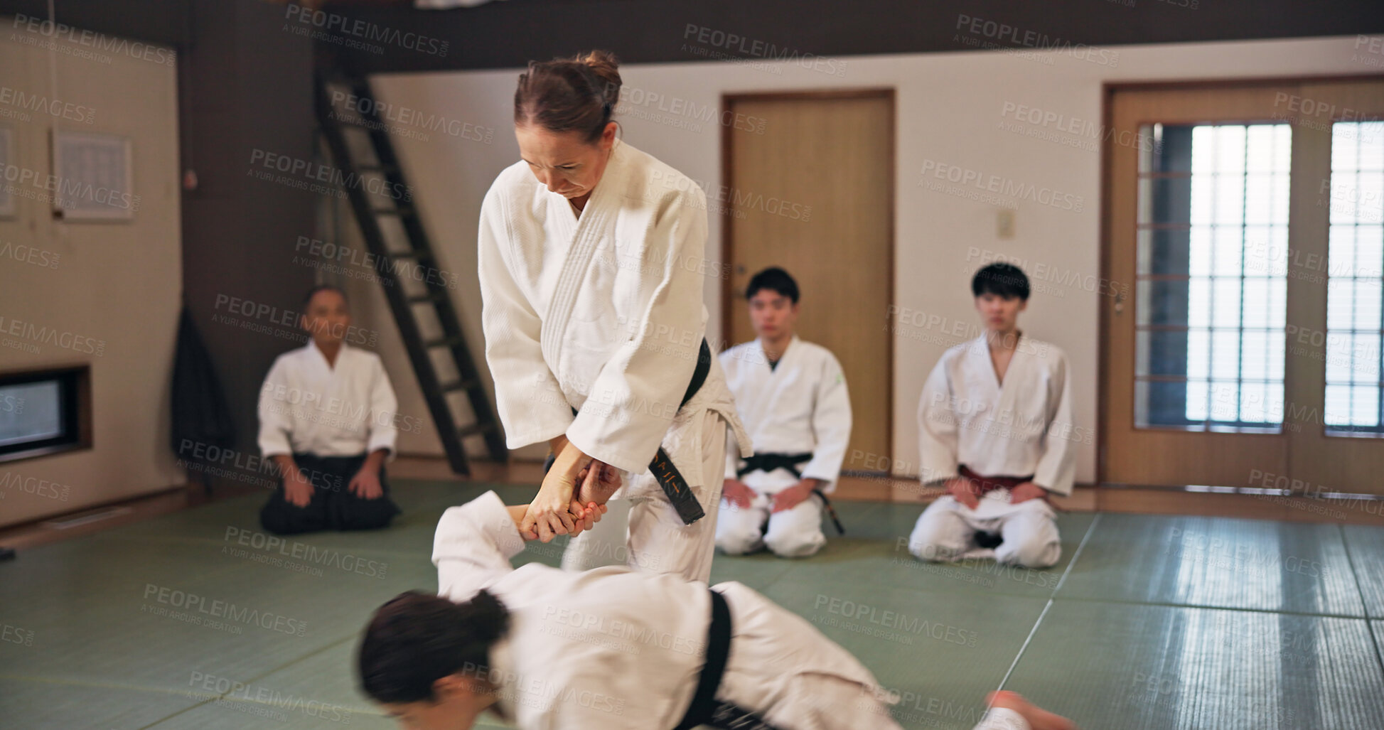 Buy stock photo Karate, martial arts and submission with people in dojo for demonstration, fitness or training. Challenge, self defense or technique with Sensei and student in Japan for combat, fighting or sports