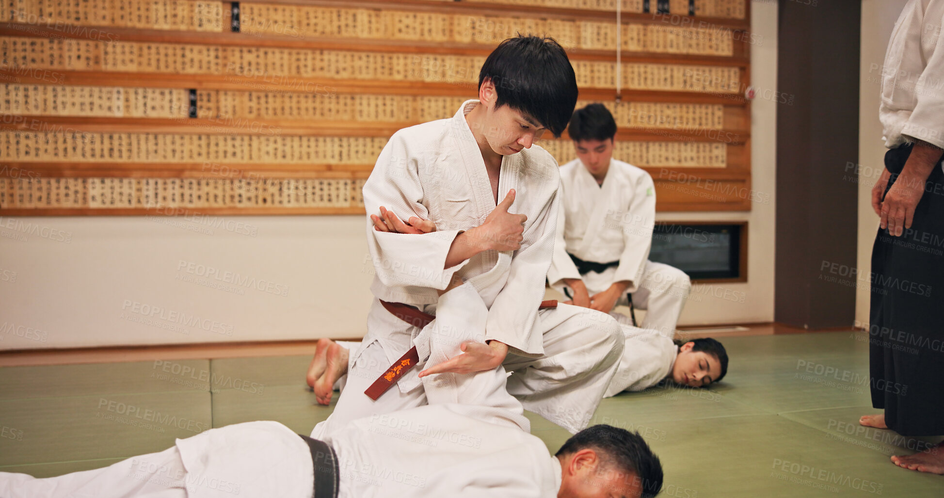 Buy stock photo Karate, martial arts and self defense with students in dojo for demonstration, fitness or training. Challenge, grappling or technique with Sensei and people in Japan for combat, fighting or sports