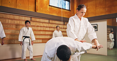 Buy stock photo Karate demonstration, submission and teacher with students in dojo for fitness or training. Learning, self defense and technique with people in Japan for combat, fighting or martial arts class