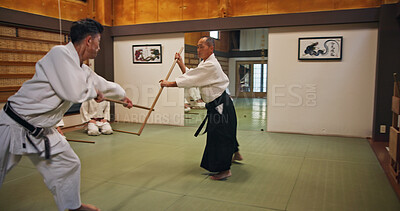 Buy stock photo Dojo, class and teacher at Aikido training in gym with wood sword Japanese martial arts and fight exercise in wellness studio. Learning, sport and weapon with people and strike practice for defence