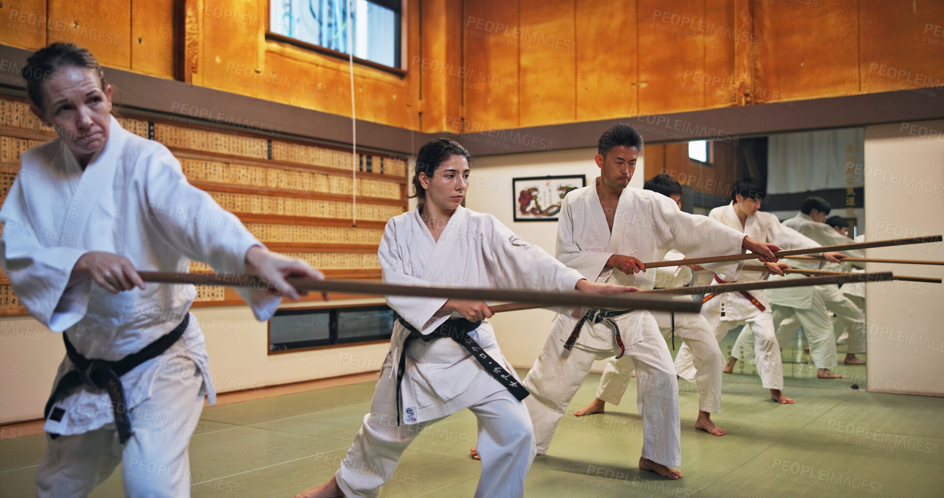 Buy stock photo Dojo, class and Aikido training in gym with wood sword Japanese martial arts and fight exercise in wellness studio. Learning, sport and bamboo weapon with people and strike practice for defence