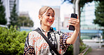 Phone, video call and woman in city for travel, vacation or adventure with connectivity online. Happy, cellphone and Japanese female person with virtual conversation for contact in town on holiday.