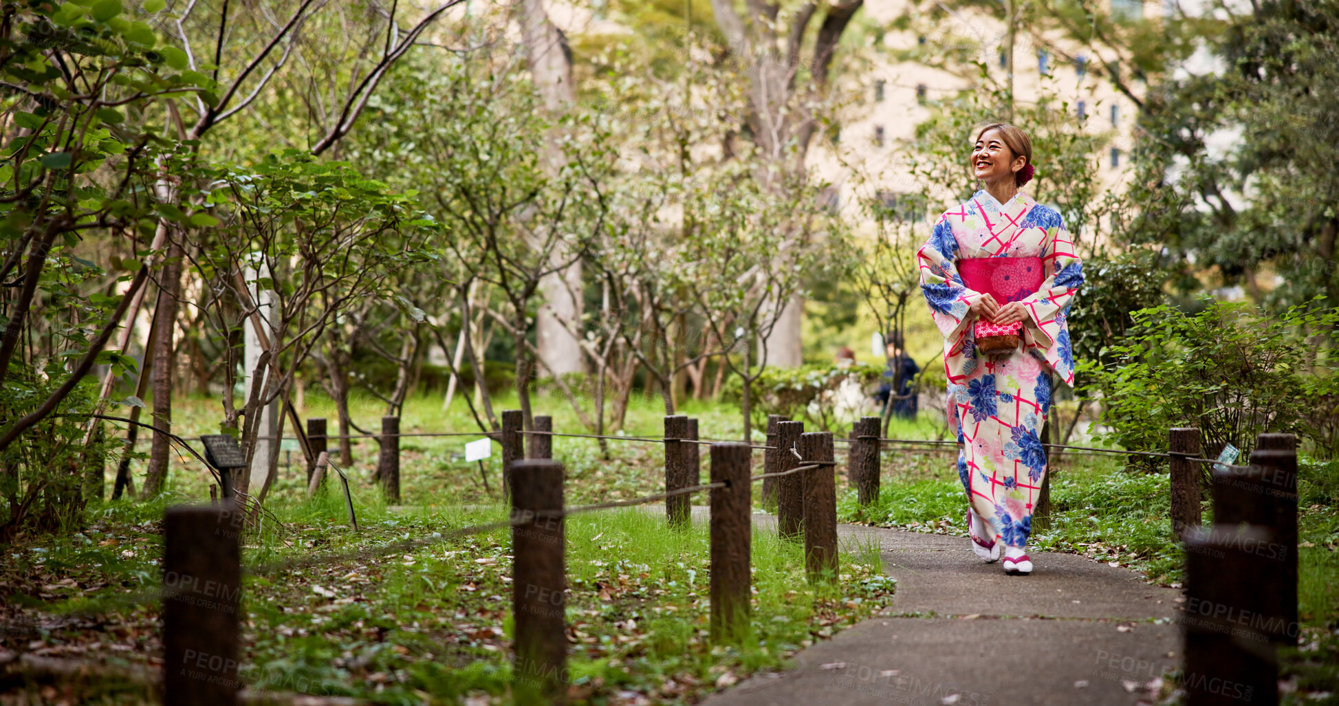 Buy stock photo Happy, asian woman and walking with kimono in park for travel, sightseeing or journey on path. Japan, female person or tourist with smile or fashion for tradition, culture or heritage in nature