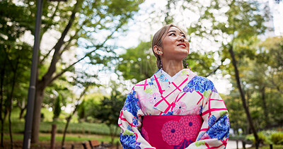 Buy stock photo Woman, thinking and walking with nature, park and travel for journey and natural sustainability. Japanese person, cultural fashion and leaves or bushes with kimono, garden and outdoor for relaxation