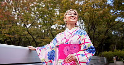 Buy stock photo Woman, smile and walking with bridge, park and travel for journey and natural sustainability. Japanese person, cultural fashion and holiday or vacation with kimono, garden and outdoor for relaxation