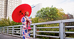 City, umbrella and woman with fashion, sightseeing and travel on urban bridge in Japan. Street, kimono and parasol with walking, outdoor and journey with smile, style and traditional Asian dress