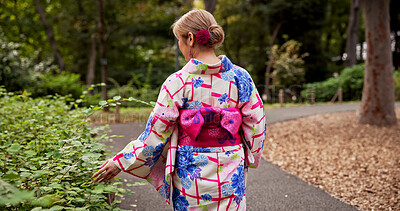 Buy stock photo Woman, back and plants with kimono, nature and travel for journey and natural sustainability. Japanese person, cultural fashion and leaves or bushes with park, garden and outdoor walk for relaxation