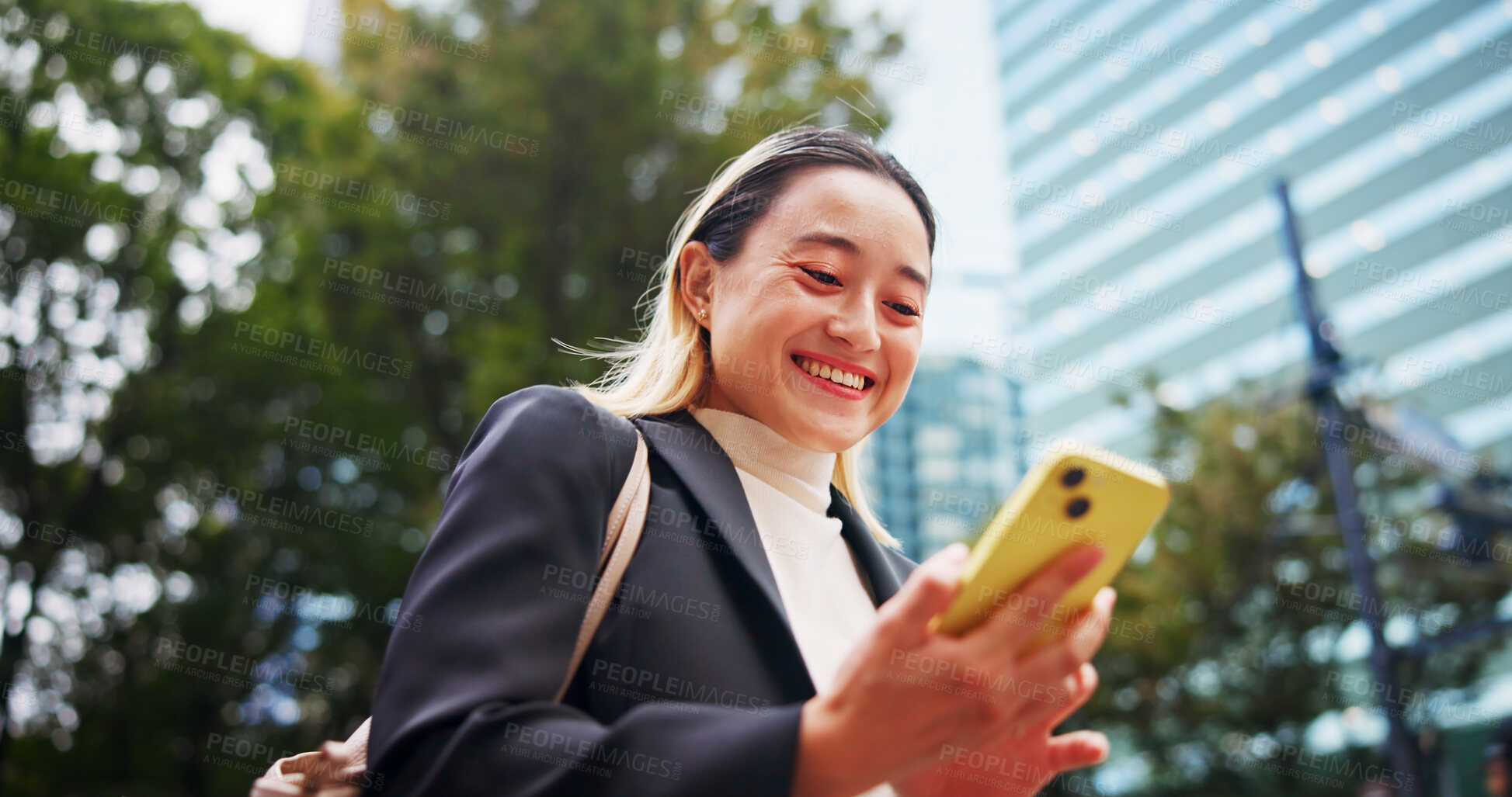 Buy stock photo Business woman, smartphone and laughing on travel in city with contact, chat and low angle on urban sidewalk. Person, phone and corporate lawyer with booking taxi, networking and commute in Japan