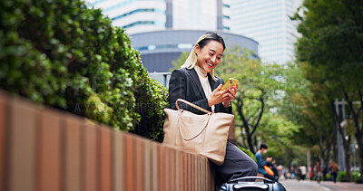 Buy stock photo Business woman, phone and luggage on travel in city with contact, happy and low angle on fence in street. Person, smartphone and corporate lawyer with booking taxi, networking and baggage in Japan