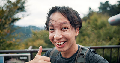 Buy stock photo Man, thumbs up and outdoor in portrait for selfie, fitness update and follower interaction on Mount Takao. Japanese influencer, like emoji or smile on bridge for travel, hiking or social media stream