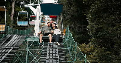 Buy stock photo Mountain, travel and happy couple on chair lift for romantic date, bonding or adventure together on Mount Takao. Holiday, Japanese man and woman on cable ride in park with love, nature and vacation