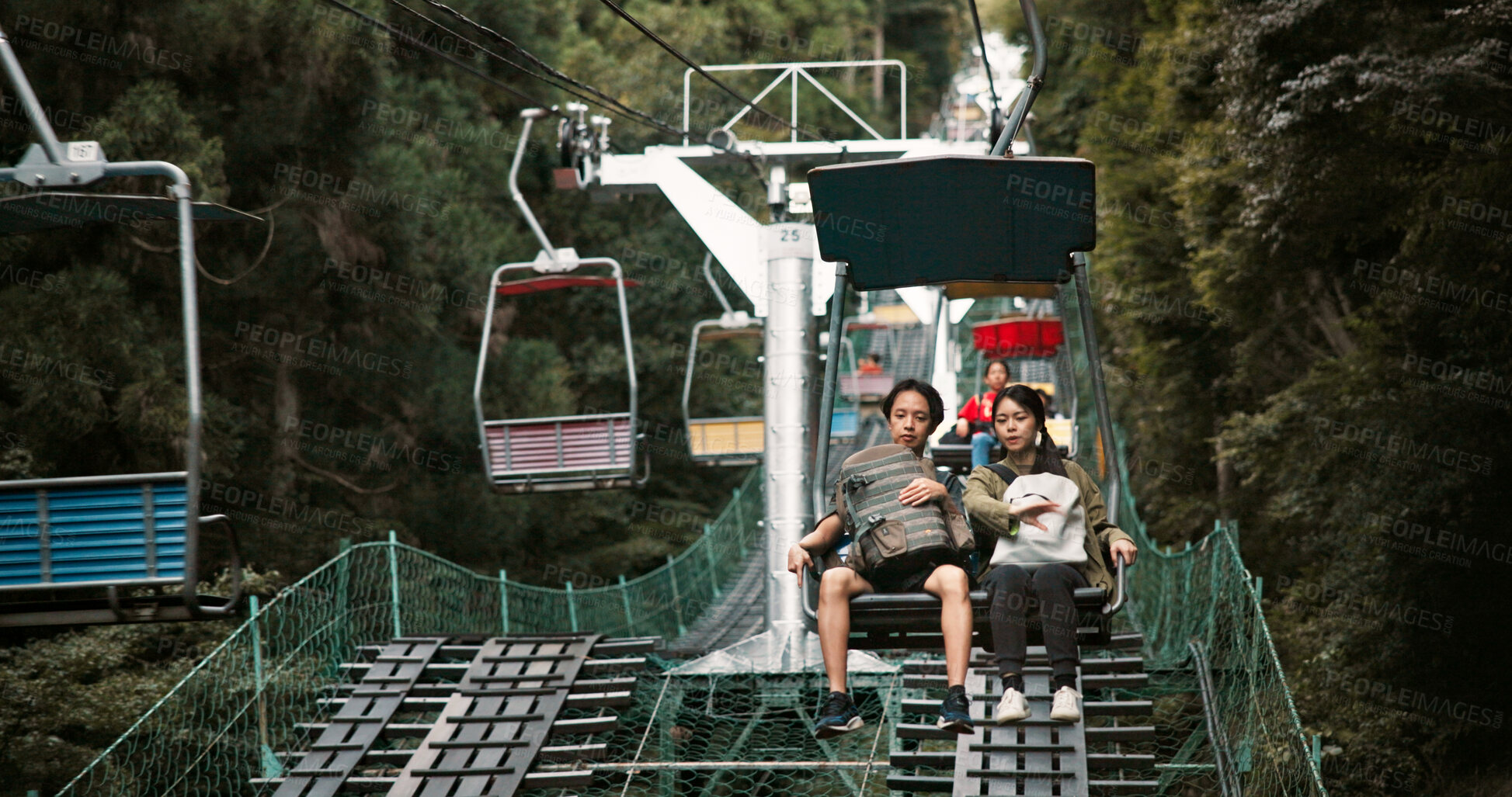 Buy stock photo Mountain, travel and couple on chair lift for romantic date, bonding or outdoor adventure together on Mount Takao. Holiday, Japanese man and woman on cable ride in park with love, nature and vacation