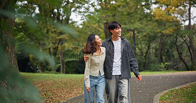 Buy stock photo Asian couple hug, laugh and walk at park for holiday, funny joke or sightseeing together. Japanese man, woman and embrace outdoor on date for romantic connection, love or happy to travel on vacation