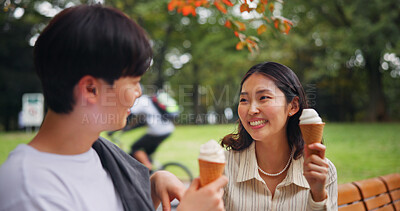 Buy stock photo Couple, date and happy in park with ice cream, bonding and share memories in Osaka. Japanese people, travel or outdoor with dessert snack for relationship development, weekend relax or smile for love
