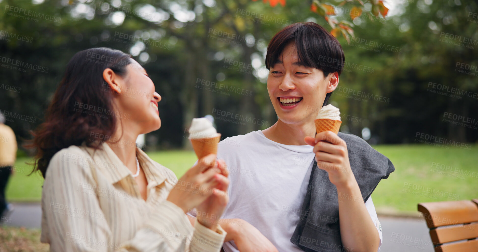 Buy stock photo Couple, date and laugh in park with ice cream, bonding and share memories in Osaka. Japanese people, happy and outdoor with dessert snack for relationship development, funny story or travel with love