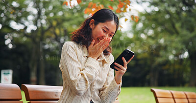 Buy stock photo Woman, laugh and outdoor with phone for social media, funny meme and humor story in Tokyo. Japanese girl, mobile and happy in park for app notification, connectivity and streaming comedy on bench