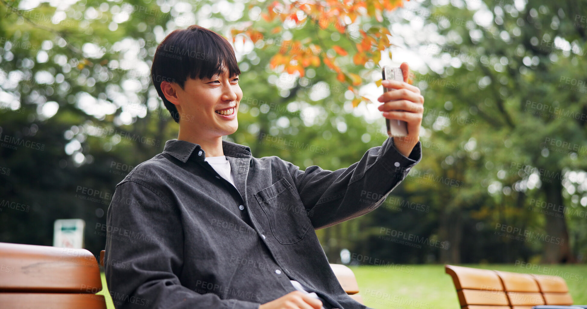 Buy stock photo Asian man, smile and selfie in park for social media, video call and connectivity in Kyoto. Happy person, relax and outdoor in Japanese garden for photography, live streaming or virtual communication