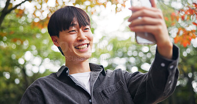 Buy stock photo Asian man, selfie and outdoor with smile for social media, video call and connectivity in Kyoto. Happy person, relax and network in Japanese garden for photography, live streaming and virtual contact
