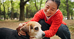 Nature, happy and woman with dog in forest for bonding, companion and love for adoption. Smile, connection and Japanese female person with beagle puppy for pet outdoor in woods for playing together.