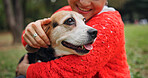 Nature, happy and woman hugging dog in forest for bonding, companion and love for adoption. Smile, connection and Japanese female person with beagle puppy outdoor in woods for embrace together.