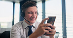 Happy man, headset and typing with phone at call center for communication, online help or web consulting at office. Japan, male person or agent with smile on mobile smartphone for language assistance