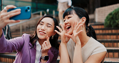 Buy stock photo Women, selfie and together on stairs in city for heart sign, partner or smile for post in street. Business people, friends and photography with love symbol, funny or emoji for social media in Japan