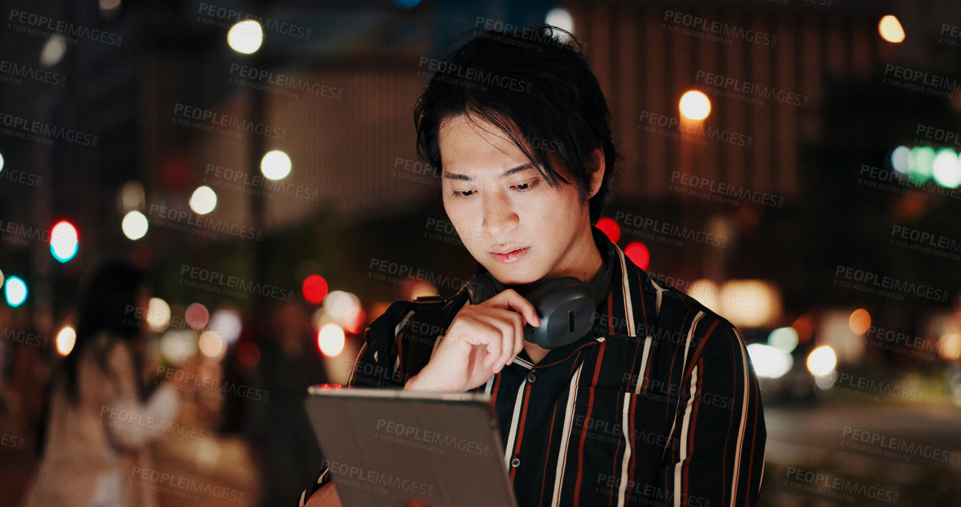 Buy stock photo Creative, serious and man with tablet, night and video editor with ideas, headphones and project. Content creation, contemplating and Asian person with tech, post production and process in Japan