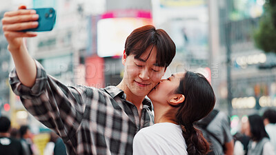 Buy stock photo City, kiss and selfie with couple on street together in Japan for bonding, romance or tourism. Love, photograph and smile of Japanese woman with man in urban town for holiday, travel or vacation