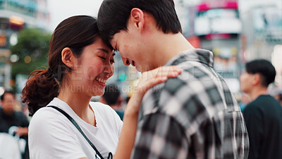 Buy stock photo Love, happy couple and forehead touch in city for support, loyalty and commitment on vacation. Japanese man, woman and embrace for romantic relationship, connection and trust partner outdoor on date
