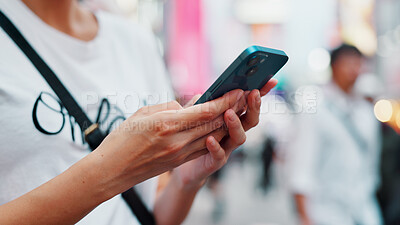 Buy stock photo Hands, phone and woman typing in city to check text, social media or blog post on account in Japan. Closeup, mobile and person outdoor for communication, notification or download chat app on internet