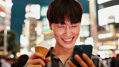 Buy stock photo Man, phone and ice cream with travel in city, night and check notification for chat, laugh or meme in street. Person, smartphone and gelato on metro sidewalk, smile and app for social media in Japan