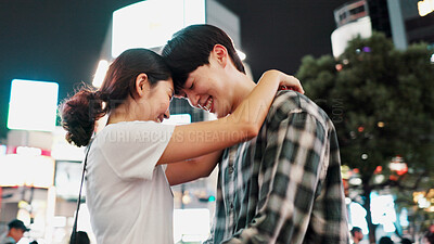 Buy stock photo Love, happy couple and hug in city at night for support, loyalty and commitment on vacation. Japanese man, woman and embrace outdoor for romantic relationship, connection and forehead touch on date