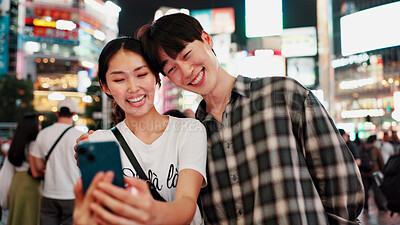 Buy stock photo Couple, selfie and night in city with smile for date, memory and travel with bonding for post on web. People, woman and man with photography, happy and profile picture on social network in Japan