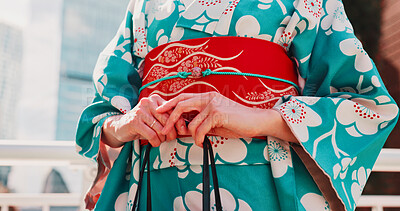 Buy stock photo Fashion, hands and woman in kimono outdoor for traditional Japanese style, cultural elegance and heritage with bag. Floral pattern, fabric or person in yukata in city for indigenous outfit or closeup