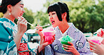 Kimono, sharing and slushy with Japanese women outdoor in city together for bonding as friends. Conversation, kakigori and taste with people eating at carnival for culture, heritage or tradition