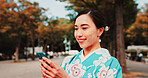 Cellphone, travel and Japanese woman in city with traditional kimono networking on social media. Happy, phone and female person with cultural dress for stylish outfit in town for journey with contact