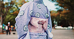 Culture, woman and kimono fashion in city for heritage, traditional style and floral pattern design. Back, yukata and person with obi belt bow in urban town for festival ceremony or identity in Japan