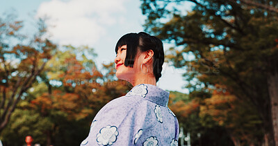 Buy stock photo Green, park and girl in kimono with smile, thinking and outdoor sightseeing in nature with low angle. Culture, inspiration and Japanese woman in garden for traditional spring festival from behind