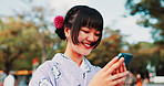 Phone, travel and Japanese woman in city with traditional kimono networking on social media. Happy, cellphone and female person with cultural dress for stylish outfit in town for journey with contact